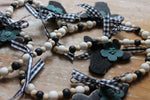 Mini Black Heifer Head Garland with Teal Flowers